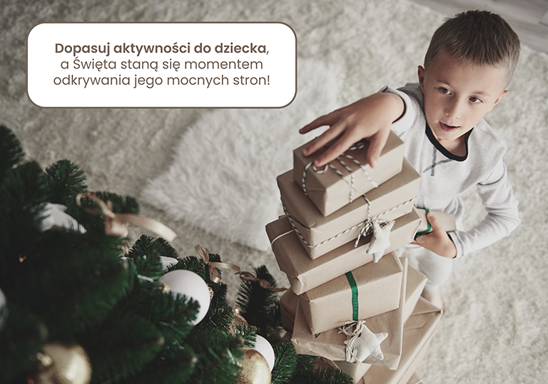 Boy arranging  stack of christmas presents